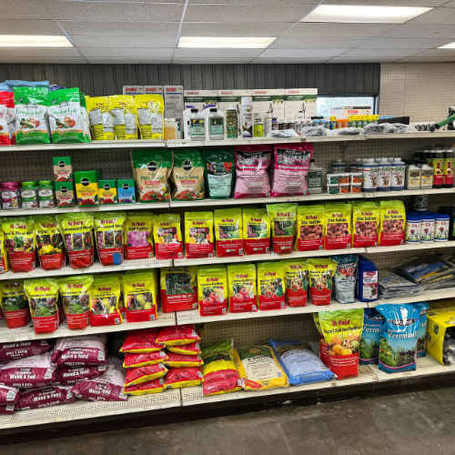 A store aisle filled with various brands and types of dog food on shelves.
