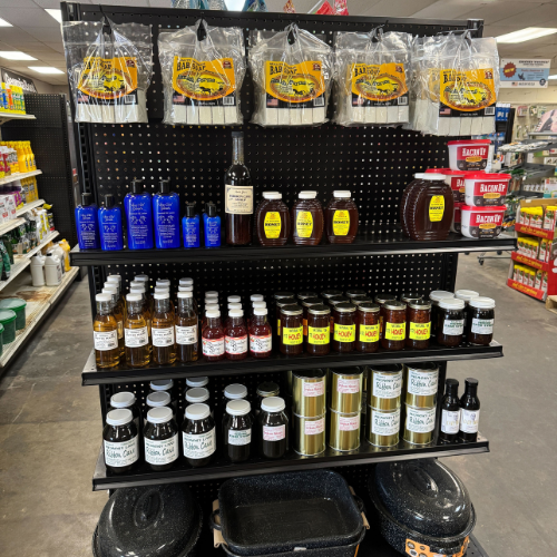 Store display of assorted grooming and personal care products, neatly organized on black shelves. Labels feature natural and classic branding.