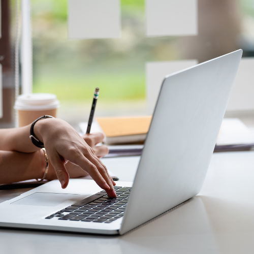 Hands typing on a laptop.